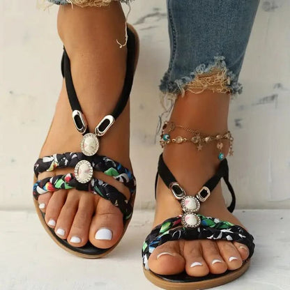 Sandalias planas con tiras trenzadas y adornos de gemas